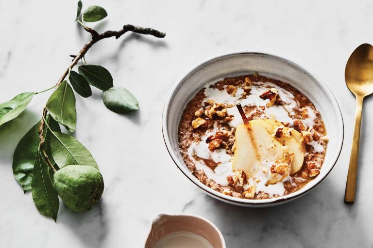a bowl of pear porridge and a dish of honey